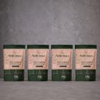 Pack de cuatro bolsas de 250 g de nuez mariposa Solo Nuez, partida manual, 100% natural, sobre fondo gris.